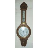 A banjo barometer in oak case; an ash framed mirror, 93 x 53 cm overall