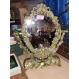 A brass classical style swing dressing table mirror decorated with cherubs etc, height 38cm