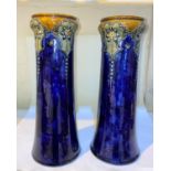 A pair of Art Nouveau period cylindrical Royal Doulton stoneware vases decorated in relief with