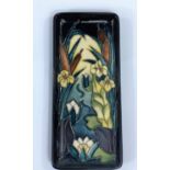 A MOORCROFT rectangular dish decorated with flowers, 20cm