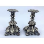 A pair of Rococo style, white metal candlesticks, height 17cm.