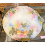 An opaque glass light bowl with coloured pansy decoration.