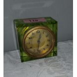 A vintage Uranium glass cased bedside clock with circular gilt dial and Arabic numerals