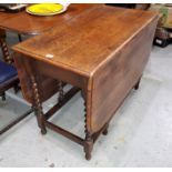 An oak 'D' end drop leaf dining table on barley twist legs