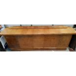 An imposing German Art Deco burr walnut sideboard with 5 doors, raised pediment back and plinth