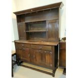 An early 20th century oak dresser of Art Nouveau style with applied iron hinges and handles 152cm