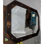 A 1920's oak framed mirror with canted corners, 89 x 64 cm overall