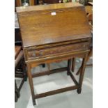 A small oak bureau with fall front over single carved drawer, most fittings present and some are