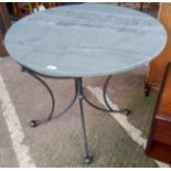 A breakfast table with circular slate top on 4 wrought metal legs