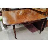 A Georgian mahogany large drop leaf dining table with turned legs