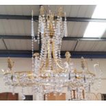 A gilt circular chandelier with drops in the classical manner