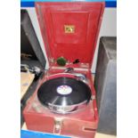 An HMV portable record player and a selection of vintage records