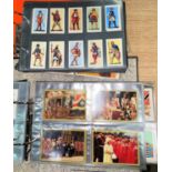 A selection of cigarette cards including military figures, medals, royals etc