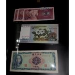An album of World bank notes including Chinese, Japanese and other examples