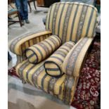 An armchair reupholstered in yellow/blue regency stripe