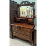 An Edwardian walnut dressing table with central mirror, 2 long, 2 short and 2 jewellery drawers with