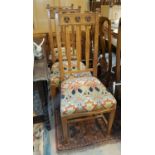 A set of 6 oak Arts and Crafts rail back dining chairs with squared tapered legs, other carved