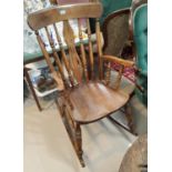 A Victorian elm rocking armchair with fiddle back