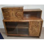 An early 20th century stained and grained bookcase / cocktail cabinet with fall front, sliding glass