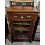 An Edwardian mahogany music cabinet enclosed by glazed door, with frieze drawer