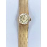 A ladies 9 carat hallmarked gold wristwatch on 9 carat integral mesh strap, 27 gm gross