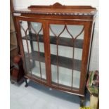 A 1920's mahogany china cabinet with 2 doors; a lime washed pine chest of drawers