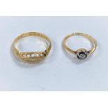 An Edwardian18 carat hallmarked gold ring with 5 small graduating diamonds in split shank setting; a