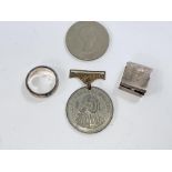 A large white metal ring, stamped 925; a small white metal pill box stamped 925; 2 other items.