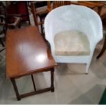 A white Lloyd Loom armchair and an oak coffee table