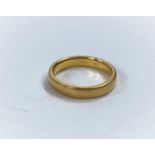 A wedding ring, 5.4 gm, tests as approx 18ct