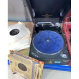 A Columbia portable record player and a selection of vintage records