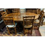 An oak circular, pedestal extending dining table with on spare leaf, in the Titchmarsh & Goodwin