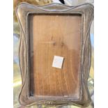 A hallmarked silver Art Nouveau photo frame of shaped rectangular form, height 17 cm; silver plate