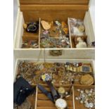 A selection of costume jewellery including brooches, gilt and white metal items