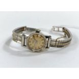 A white metal ladies wrist watch "precision" by Gruen Geneve on reticulated white metal strap un-