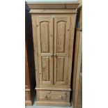 A pine small wardrobe with double doors and base drawer