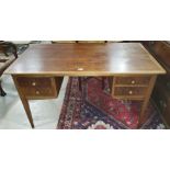 A 1950's mahogany kneehole desk by designer Ian Henderson, with 4 short drawers, on square taqpering