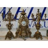 A large Rocco style three piece clock garniture central gilt metal clock and two matching 6 branch