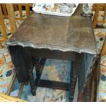 A 1930's oak dining table with canted scalloped top, on barley twist legs