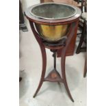 An Edwardian inlaid mahogany jardinière stand in the Sheraton style, with circular top, brass