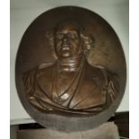 A bronze relief oval plaque of a 19th century gentleman, height 34cm.