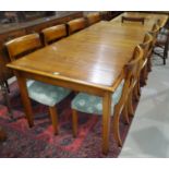 A period style cherry wood dining table with extending crossbanded rectangular top, on square