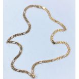 A yellow metal chain of flattened curb form, with alternating 5 link and elongated link sections,