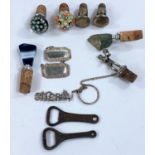 A small selection of bottle stoppers, two paperweight style a tennis player etc and bottle labels