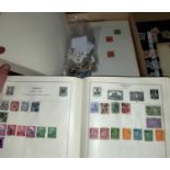 A Strand album with a vintage collection of stamps; a collection of world stamps