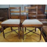 A 19th century set of mahogany dining chairs with wide top rails, drop-in fawn seats, on turned