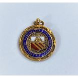 A 9ct gold 1920's Manchester & District Wednesday A.F.L Champions enamelled medal 6.8gms