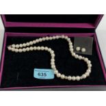 A cultured pearl necklace with matching earrings