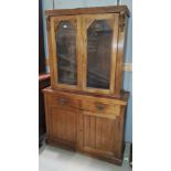 An Edwardian mahogany full height bookcase with 2 glazed doors over 2 drawers and double cupboard