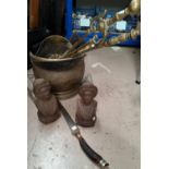 A pair of figural hearth pieces; fire irons; a coal bucket